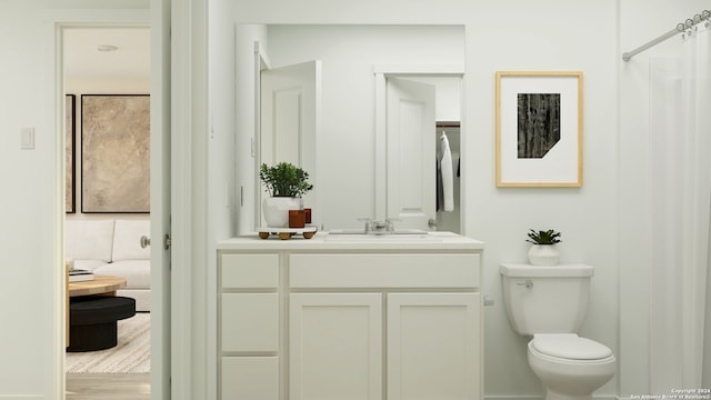 bathroom featuring vanity, toilet, and hardwood / wood-style flooring