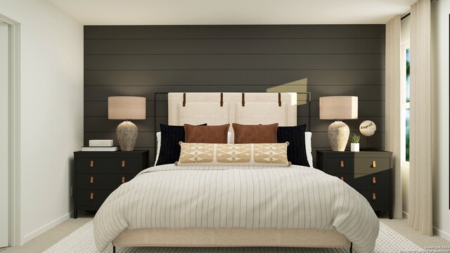 bedroom featuring light colored carpet and wood walls