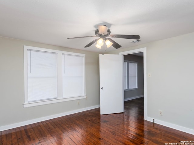 spare room with ceiling fan and dark hardwood / wood-style flooring