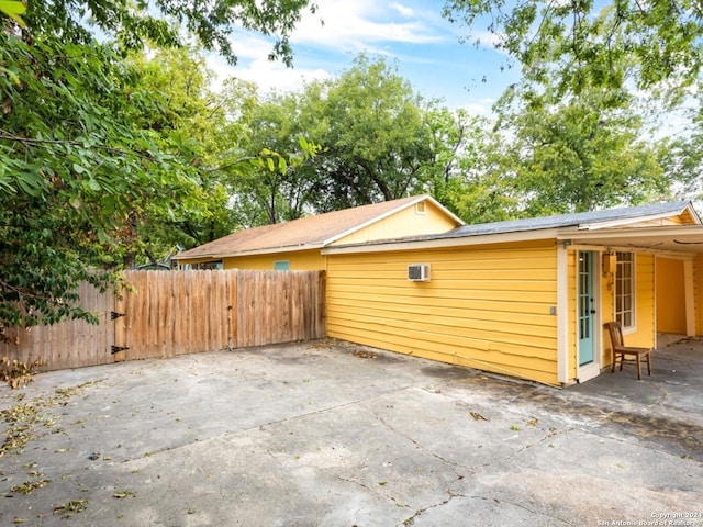 view of property exterior with a patio area