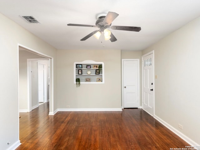 empty room featuring ceiling fan and dark hardwood / wood-style floors