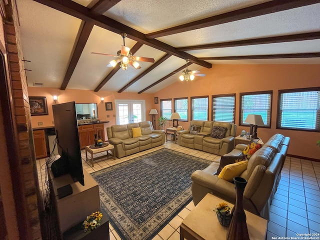 living room with lofted ceiling with beams, ceiling fan, a textured ceiling, and light tile patterned floors