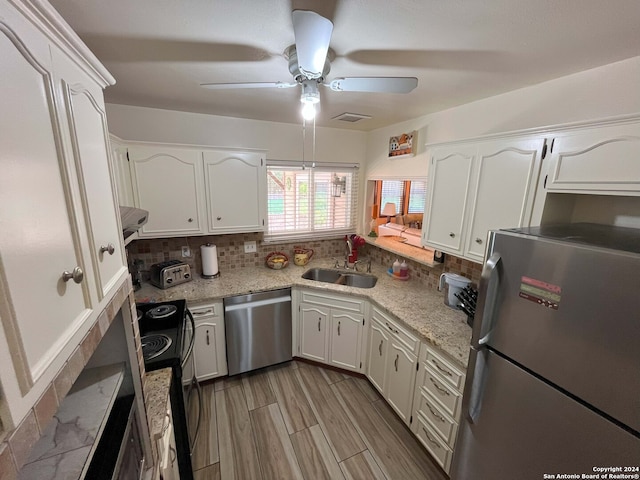 kitchen featuring sink, white cabinetry, stainless steel appliances, and tasteful backsplash