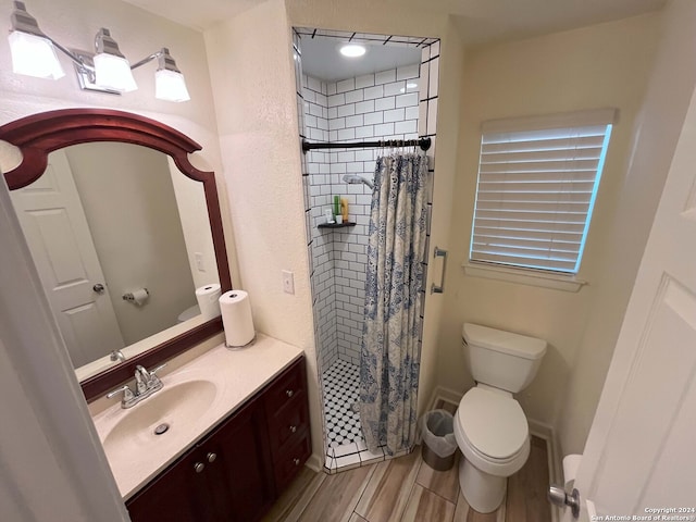 bathroom featuring vanity, a shower with shower curtain, hardwood / wood-style flooring, and toilet