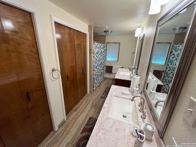 bathroom featuring vanity and a textured ceiling