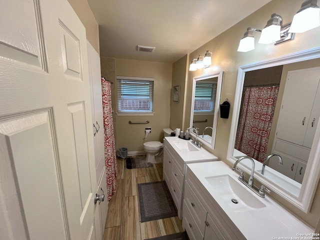 bathroom featuring vanity, hardwood / wood-style floors, and toilet