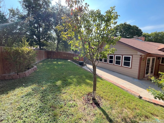 view of yard featuring french doors and a patio