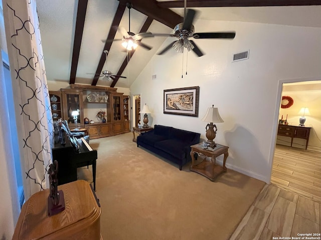 living room with beam ceiling, high vaulted ceiling, and light wood-type flooring