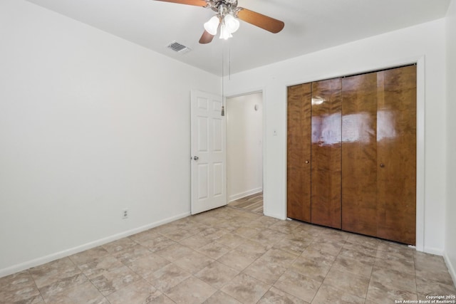 unfurnished bedroom with visible vents, ceiling fan, and baseboards