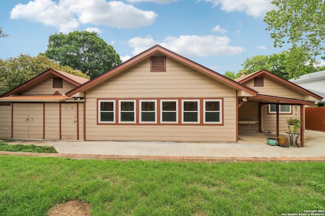 rear view of house featuring a lawn, fence, and a patio