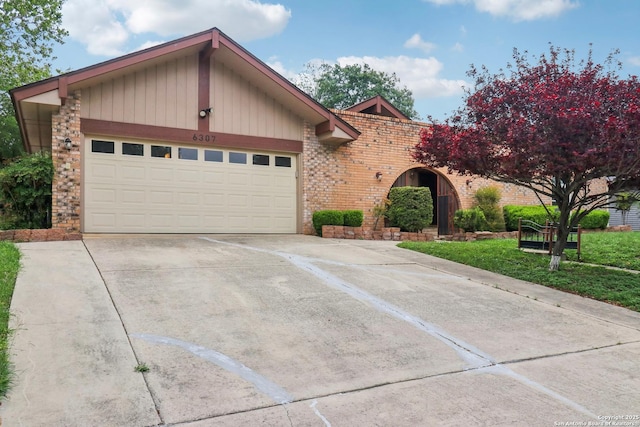 ranch-style house with brick siding, driveway, and an attached garage