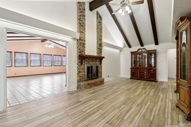 unfurnished living room with beamed ceiling, a fireplace, high vaulted ceiling, a ceiling fan, and light wood-style flooring