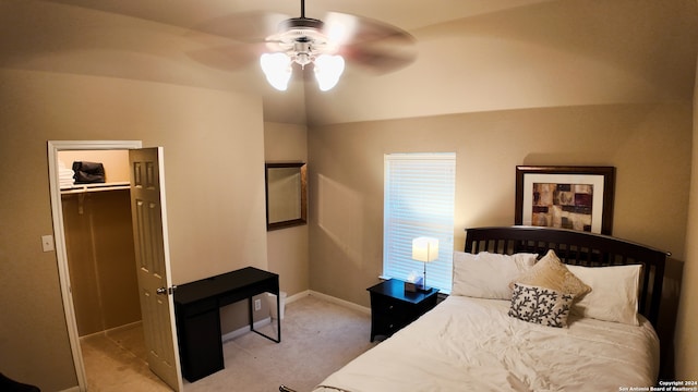 carpeted bedroom with a spacious closet, a closet, and ceiling fan