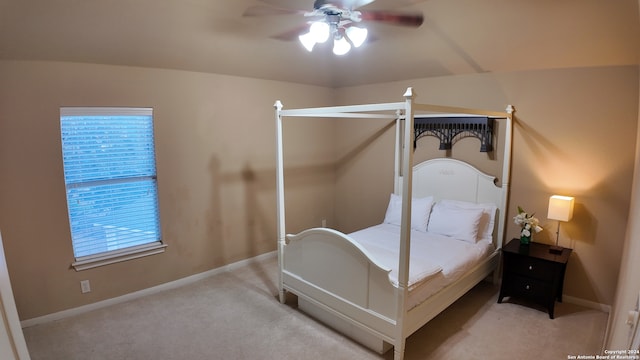 carpeted bedroom featuring ceiling fan and vaulted ceiling