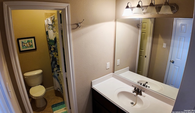 bathroom featuring vanity, toilet, and tile patterned floors