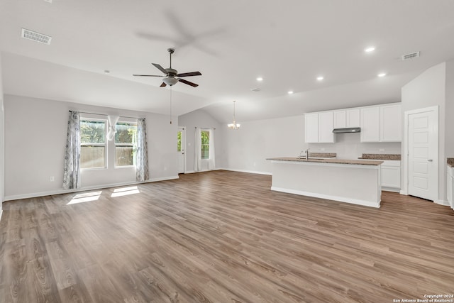 unfurnished living room featuring lofted ceiling, sink, light hardwood / wood-style flooring, and ceiling fan with notable chandelier