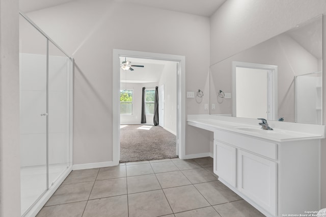 bathroom featuring a shower with shower door, ceiling fan, vaulted ceiling, vanity, and tile patterned flooring