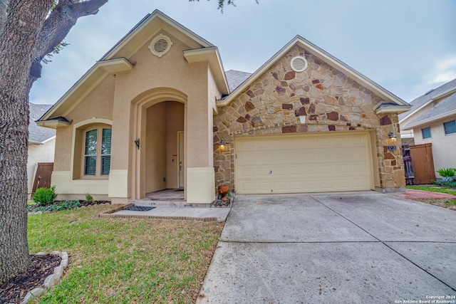 front facade featuring a front lawn and a garage