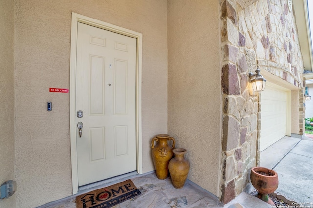 3718 Willow Walk, San Antonio, TX 78259 - view of exterior entry with stucco siding, stone siding, and a garage