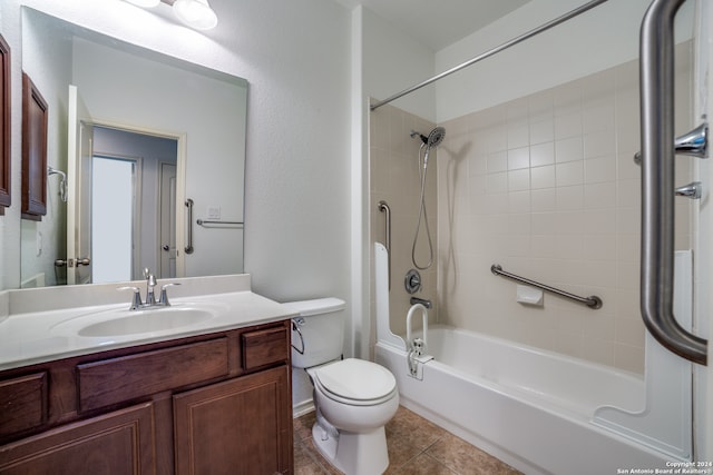 full bathroom with toilet, tiled shower / bath combo, vanity, and tile patterned flooring