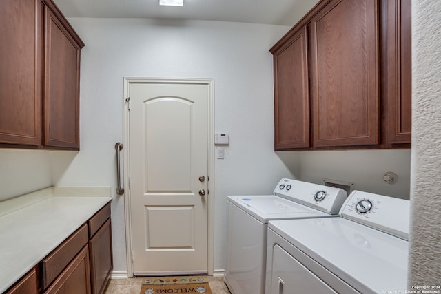 washroom with light tile patterned floors, cabinets, and separate washer and dryer