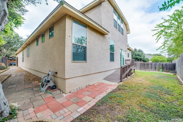 view of home's exterior with a patio and a yard