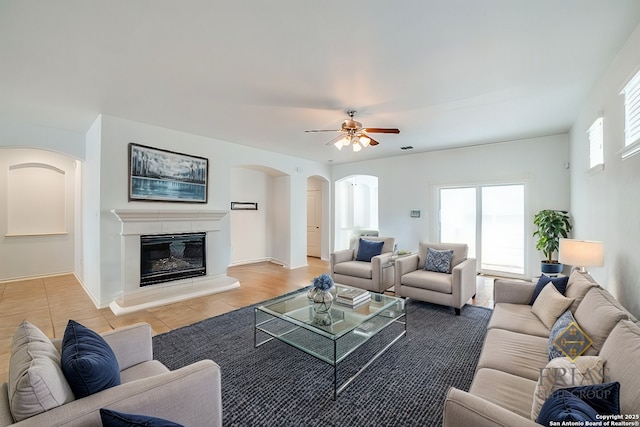 3718 Willow Walk, San Antonio, TX 78259 - living area with arched walkways, ceiling fan, and a glass covered fireplace