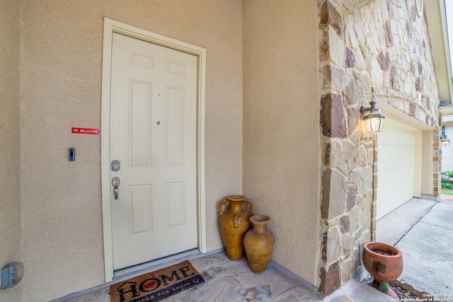 doorway to property featuring a garage