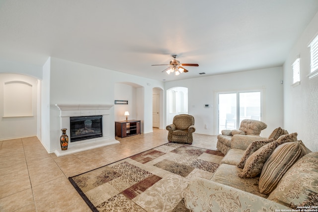 living room with ceiling fan and tile patterned floors