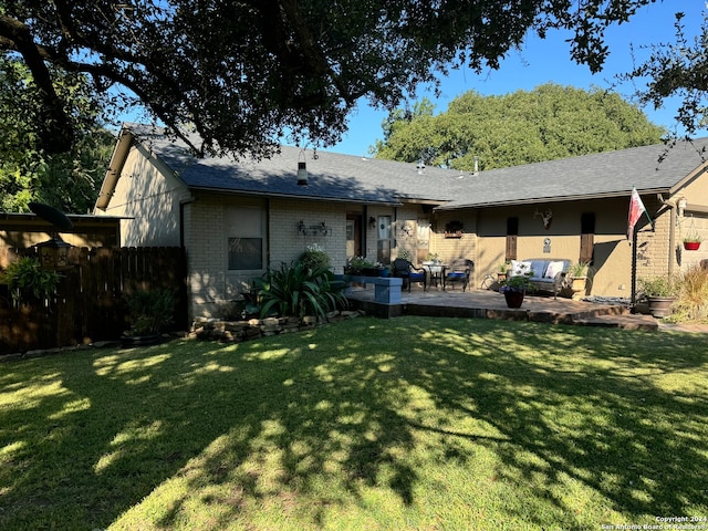 back of house with a patio and a lawn