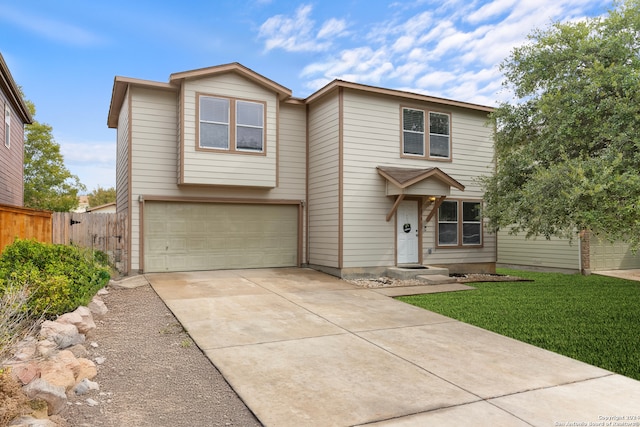 view of front of house featuring a front lawn and a garage