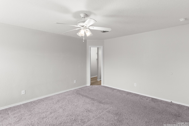 carpeted empty room with ceiling fan