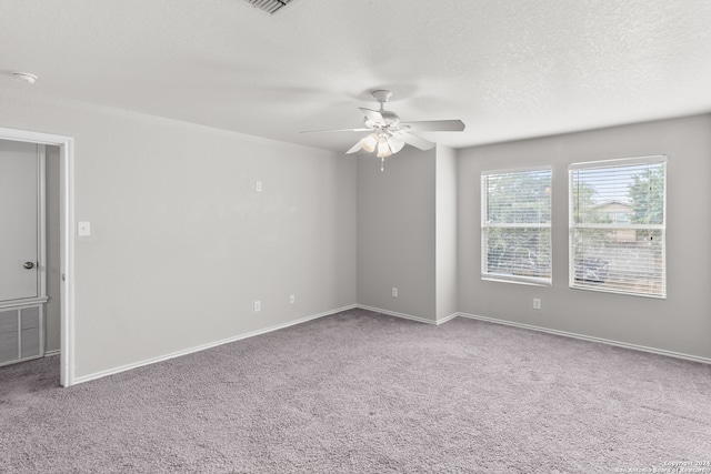 carpeted empty room with a textured ceiling and ceiling fan