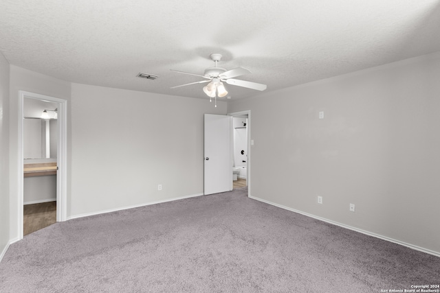 unfurnished room featuring a textured ceiling, carpet, and ceiling fan