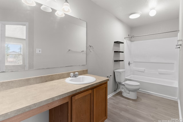 full bathroom featuring vanity, hardwood / wood-style floors, toilet, and shower / bathtub combination