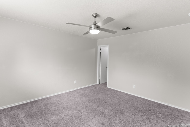 carpeted empty room featuring a textured ceiling and ceiling fan