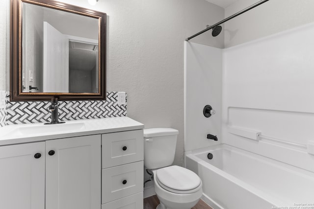 full bathroom with toilet, vanity, hardwood / wood-style flooring, decorative backsplash, and shower / bathtub combination