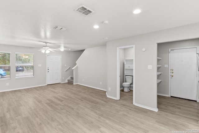 unfurnished living room with ceiling fan and light hardwood / wood-style flooring