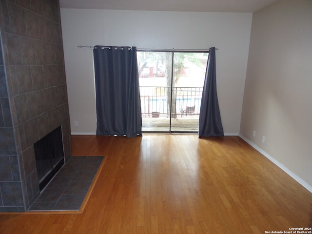 unfurnished living room featuring a fireplace and wood-type flooring