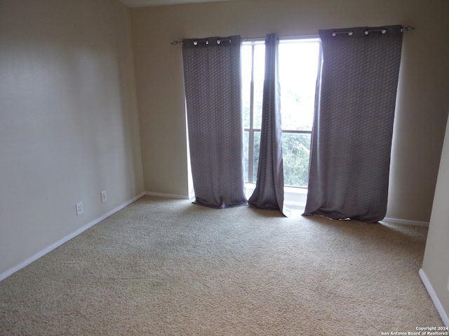 empty room featuring light carpet