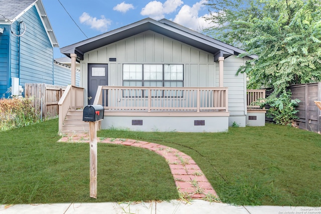 rear view of house featuring a lawn