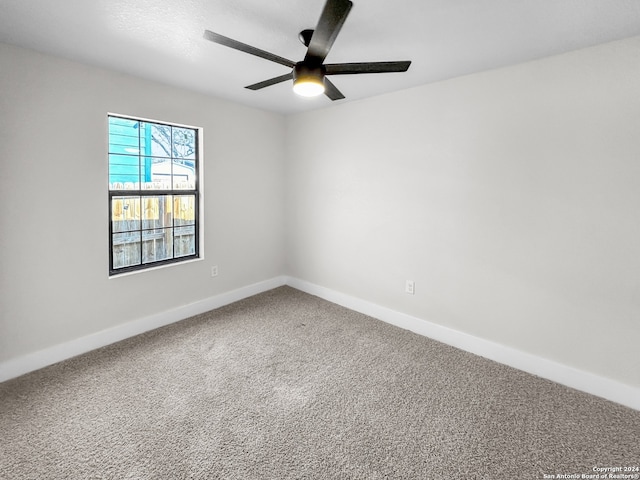 empty room with carpet floors and ceiling fan