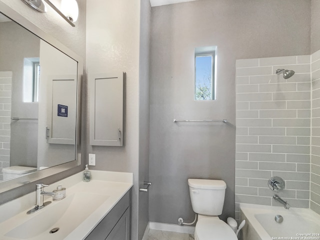 full bathroom featuring toilet, tiled shower / bath combo, and vanity