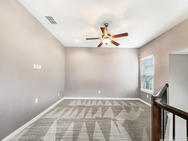 carpeted empty room featuring ceiling fan