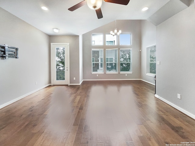 unfurnished living room with lofted ceiling, dark hardwood / wood-style flooring, and ceiling fan with notable chandelier