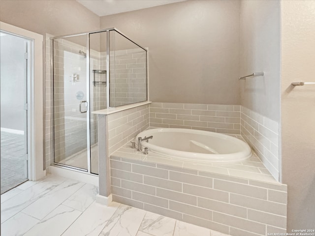 bathroom with shower with separate bathtub