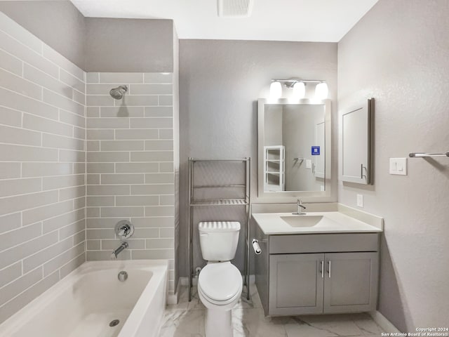 full bathroom featuring toilet, tiled shower / bath combo, and vanity