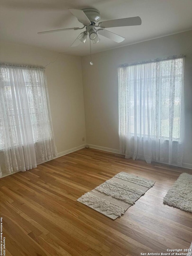 spare room featuring ceiling fan and light wood-type flooring