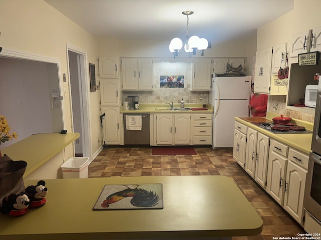 kitchen with white cabinetry, stainless steel appliances, hanging light fixtures, and sink