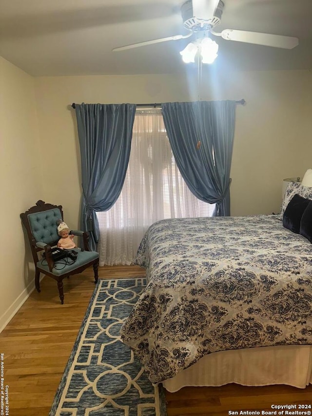 bedroom with hardwood / wood-style floors and ceiling fan